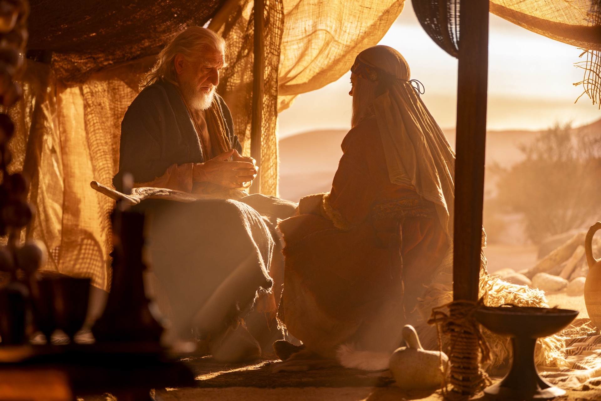 Two elders share the old stories in a desert tent